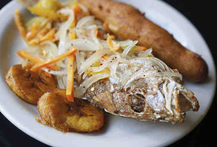 Jamaican escovitch snapper served at Pots & Pans in Akron.  (Leah Klafczynski / Akron Beacon Journal)